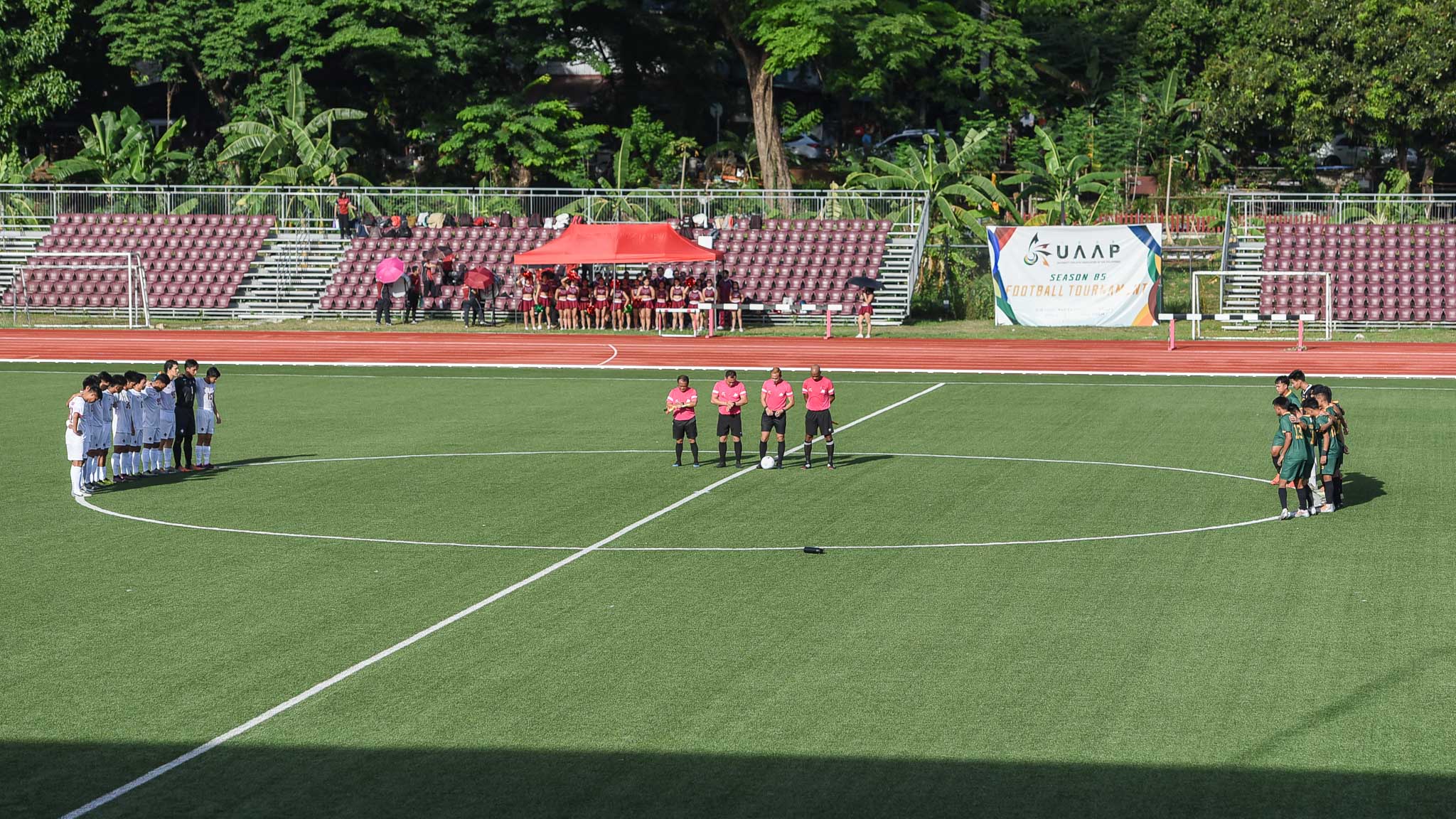 UP and FEU take a moment of silence for Yoro Sangare before their match.