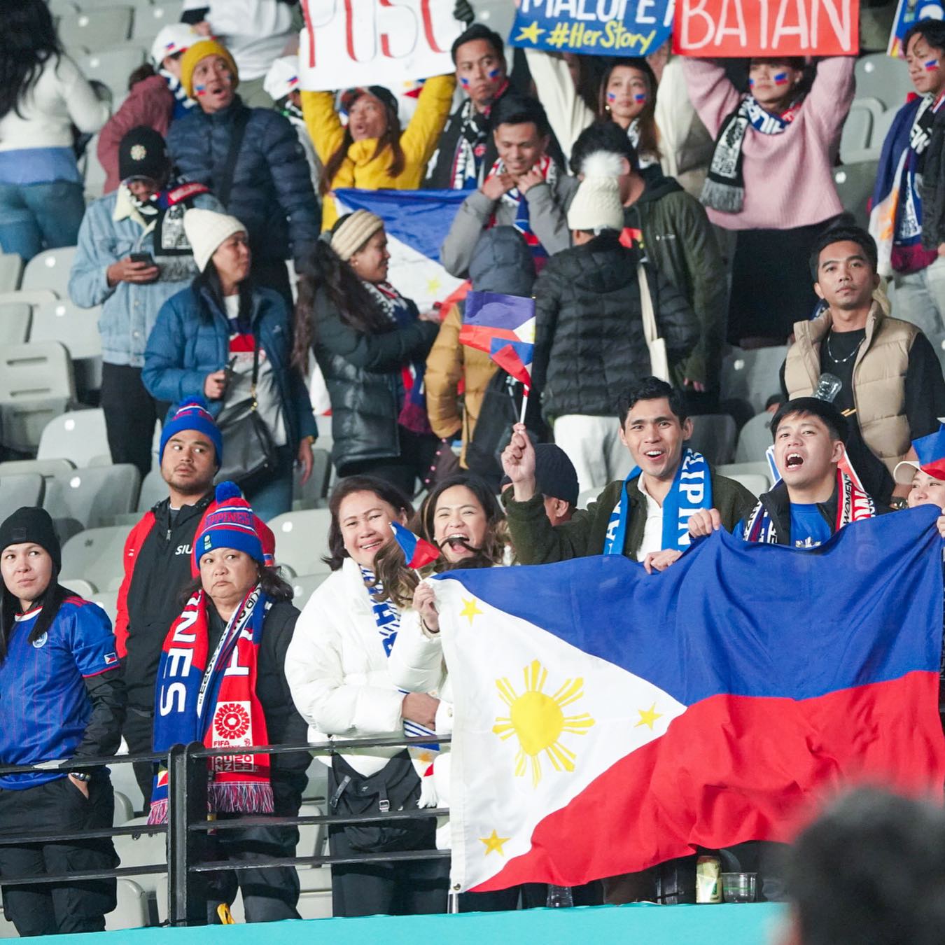 Filipino sports fans cheering on the national football team in the Women's World Cup.
