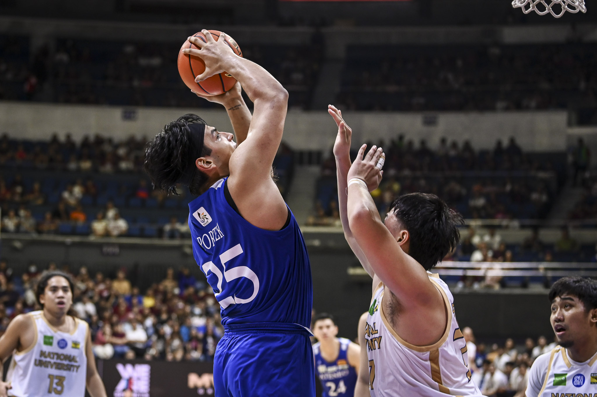 Kris Porter attempting to score over Ken Padrones