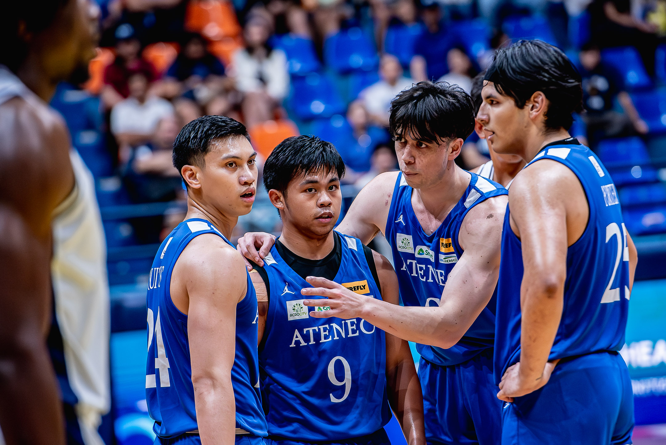 Chris Koon and Sean Quitevis gives advice to rookie point guard Jared Bahay.
