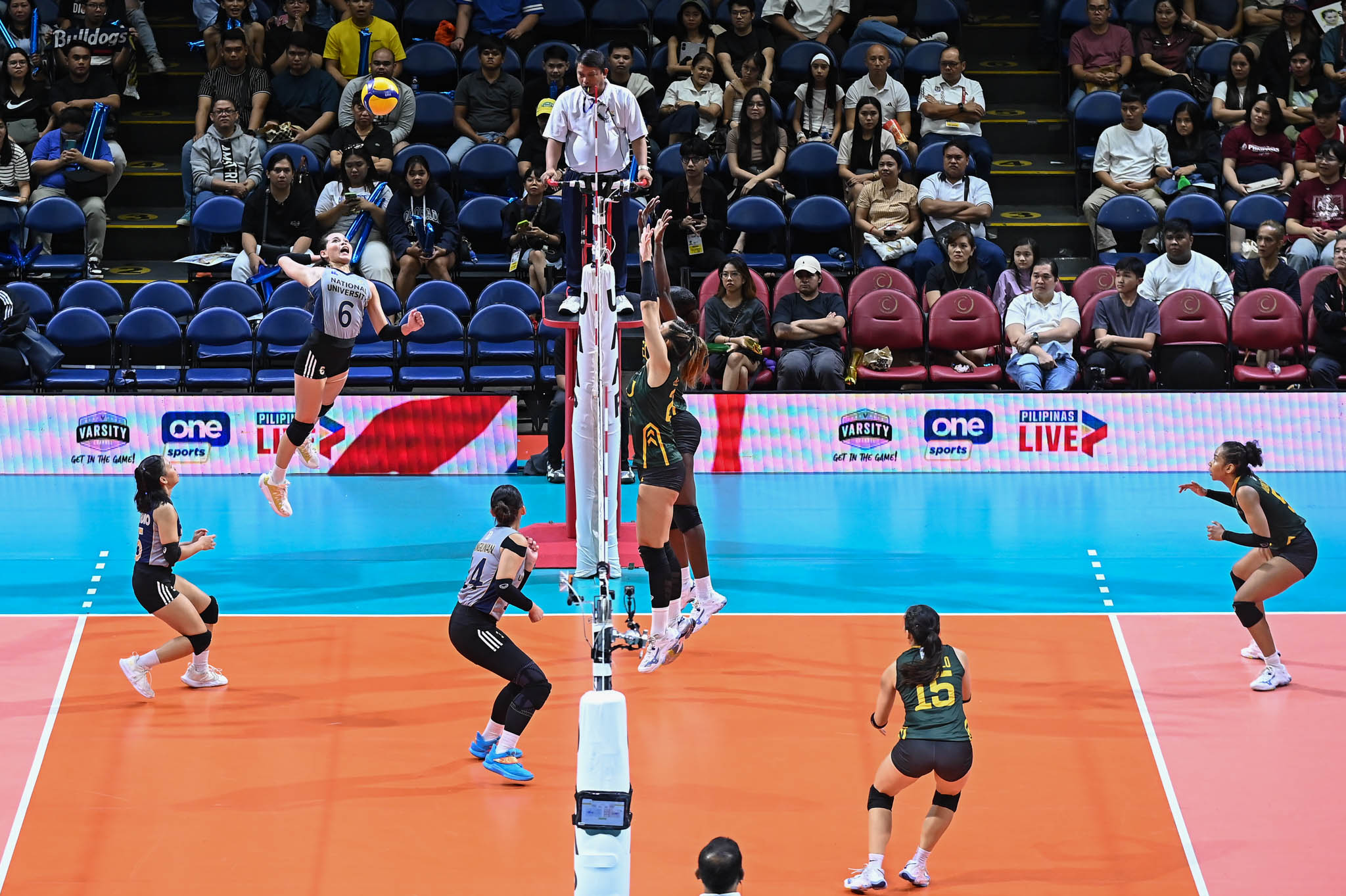NU star Vange Alinsug attempts to hurdle over an FEU twin tower of five-foot-ten Jaz Ellarina and six-foot-one Faida Bakanke.