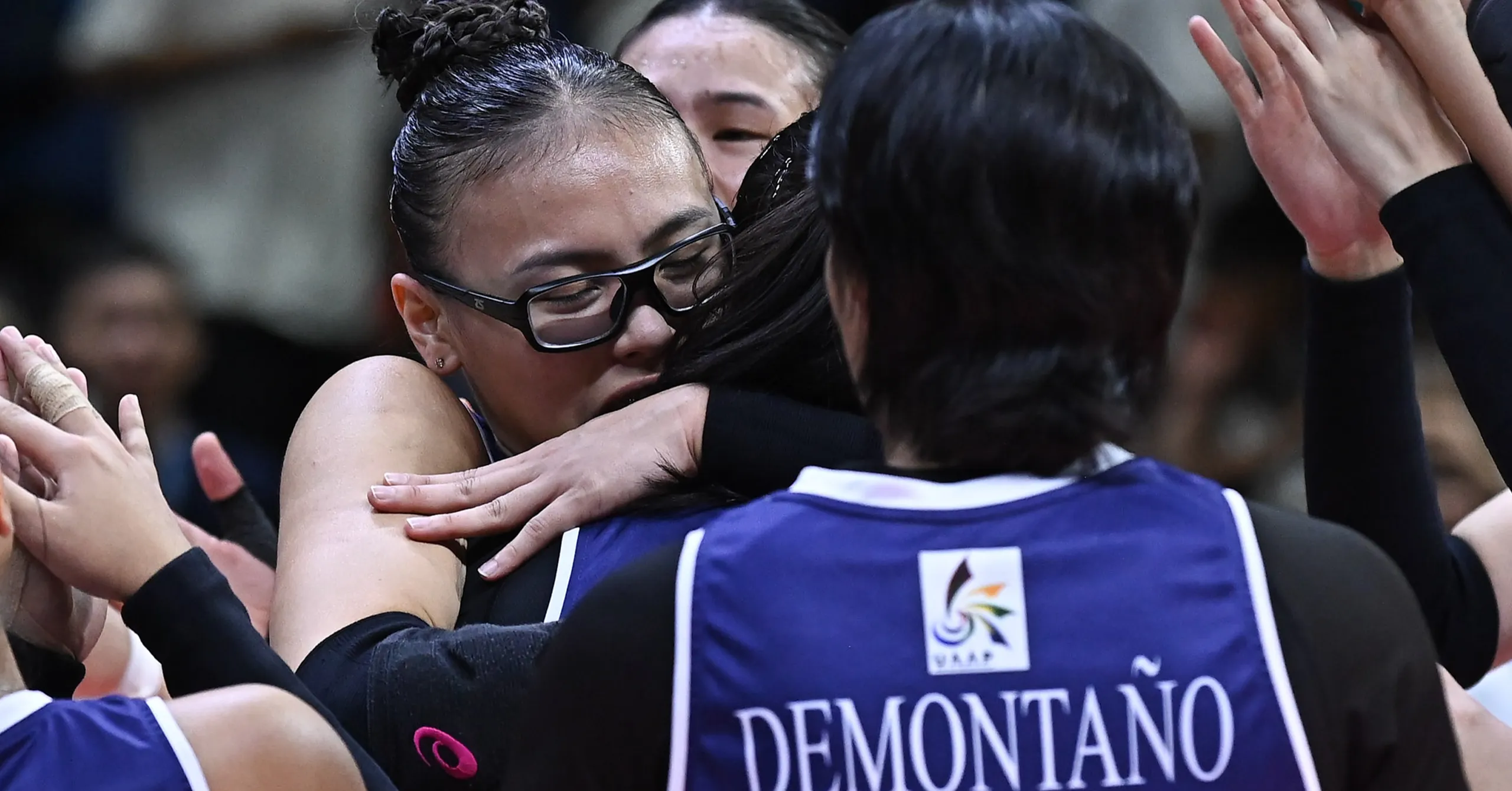 A shot of Adamson's Shaina Nitura hugging her teammate