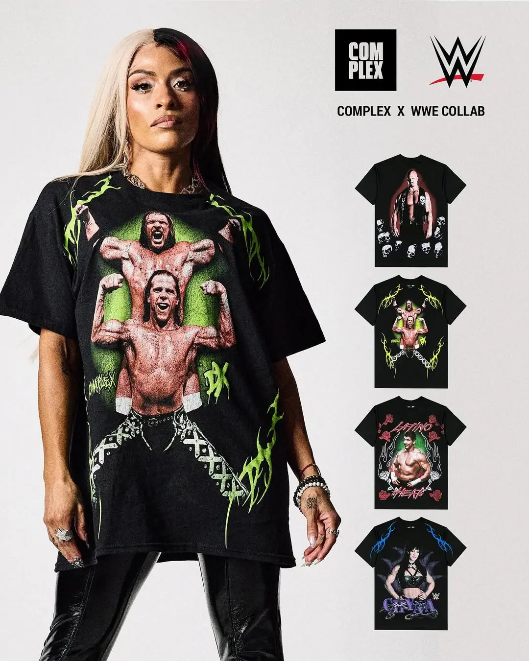 Oversized black T-shirt with a bold graphic of two wrestlers flexing, green neon flames along the sides worn by a model.