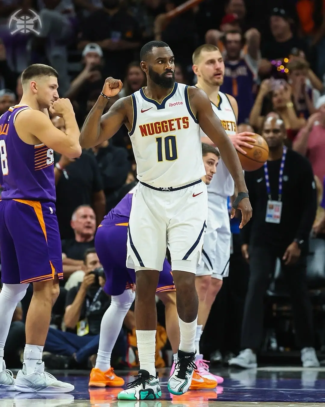 Saveclipapp_656420181_18568475104024771_6357615357736782991_n - the game Denver Nuggets guard wearing number 10 in a white jersey, fist raised in celebration during a game, with defenders and fans in the background