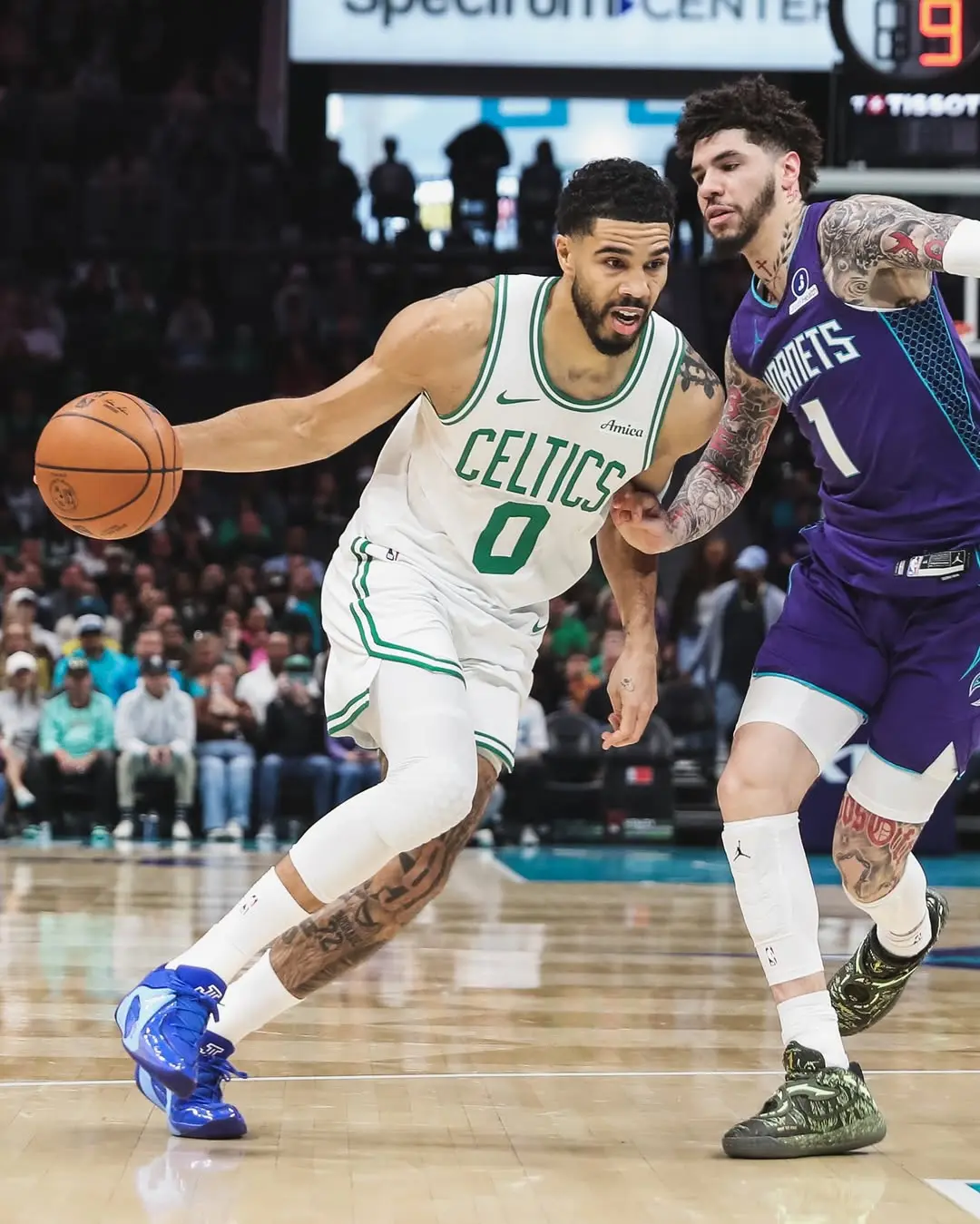 Saveclipapp_657711843_18576337456006729_8590499386531558174_n - the game Basketball player in Celtics white jersey dribbles past defender on a fast drive toward the basket during a game.