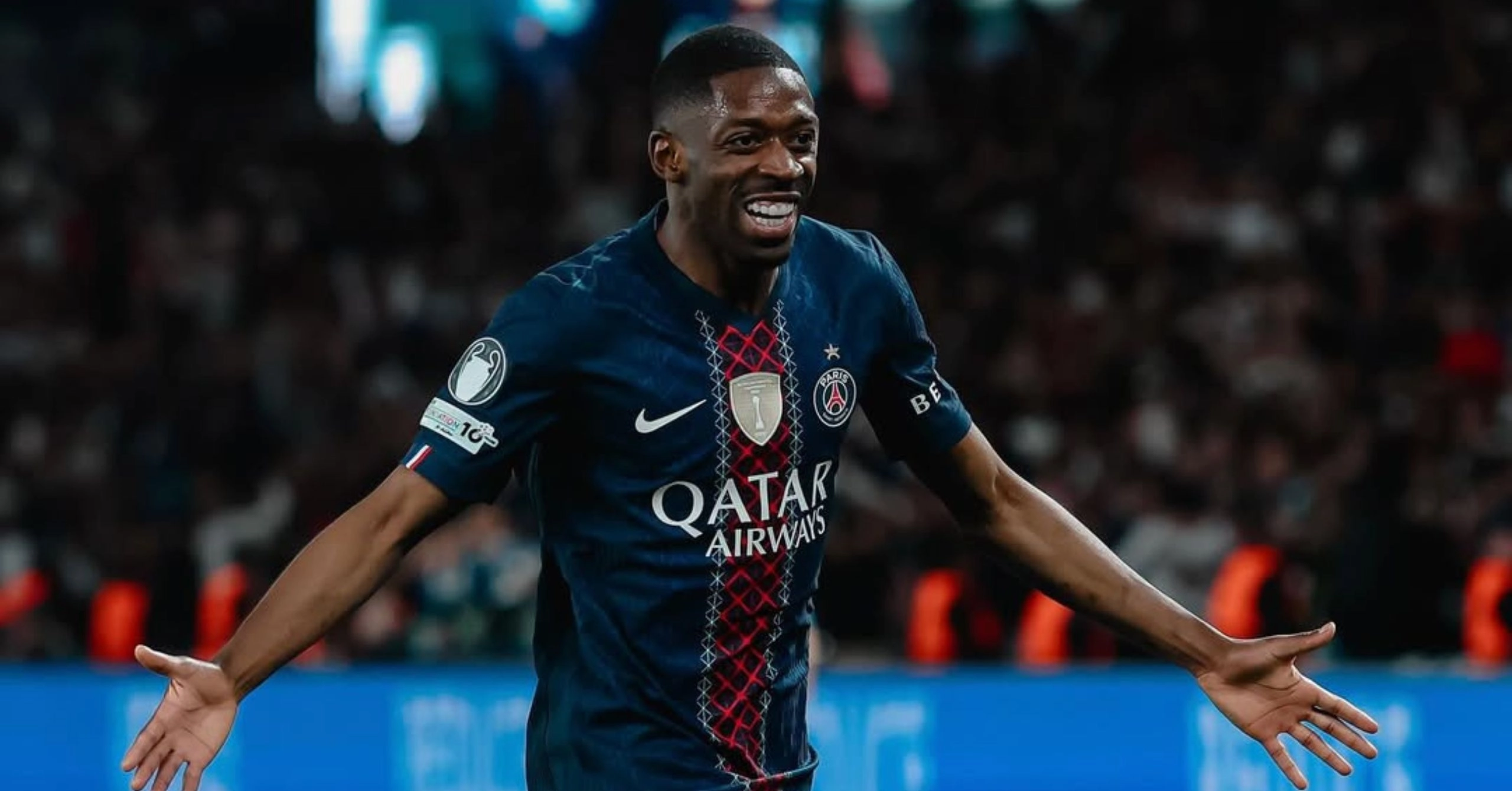 Paris Saint-Germain player celebrating a goal with arms outstretched in a navy kit with Qatar Airways sponsor visible on the chest