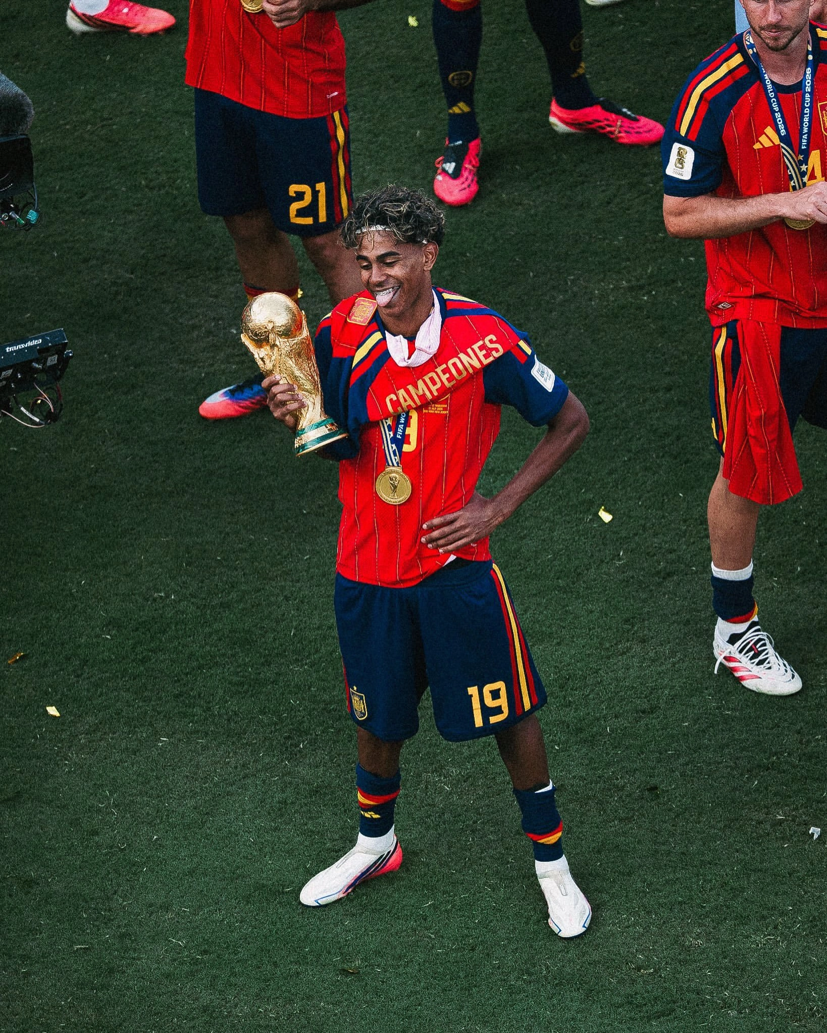 Lamine Yamal posing with the FIFA World Cup trophy.